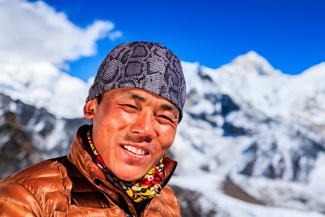 Portrait of Nepali Sherpa, Mount Makalu on background, Nepal